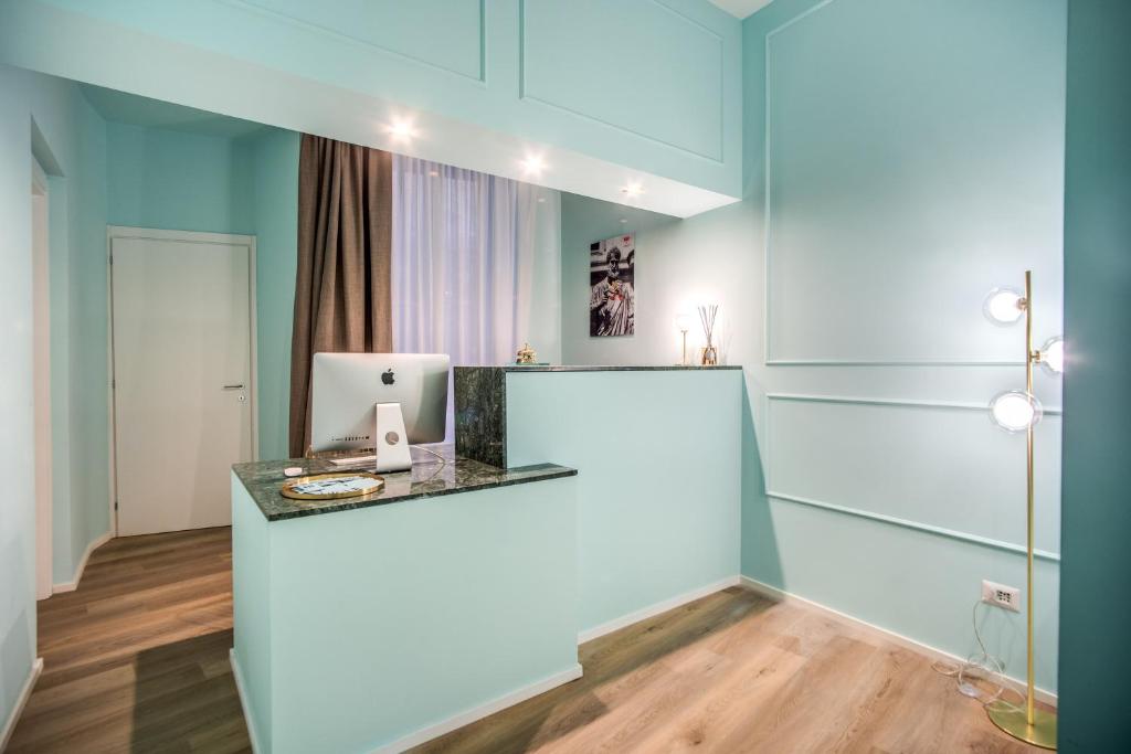 a room with a desk with a computer on it at Capranica Private Suites in Rome