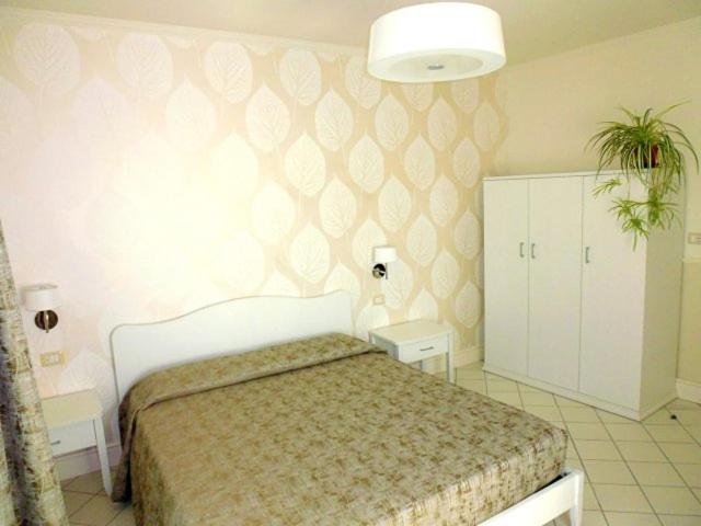 a bedroom with a large bed in a room at Le Camere del Vascello d'Oro in Carrù