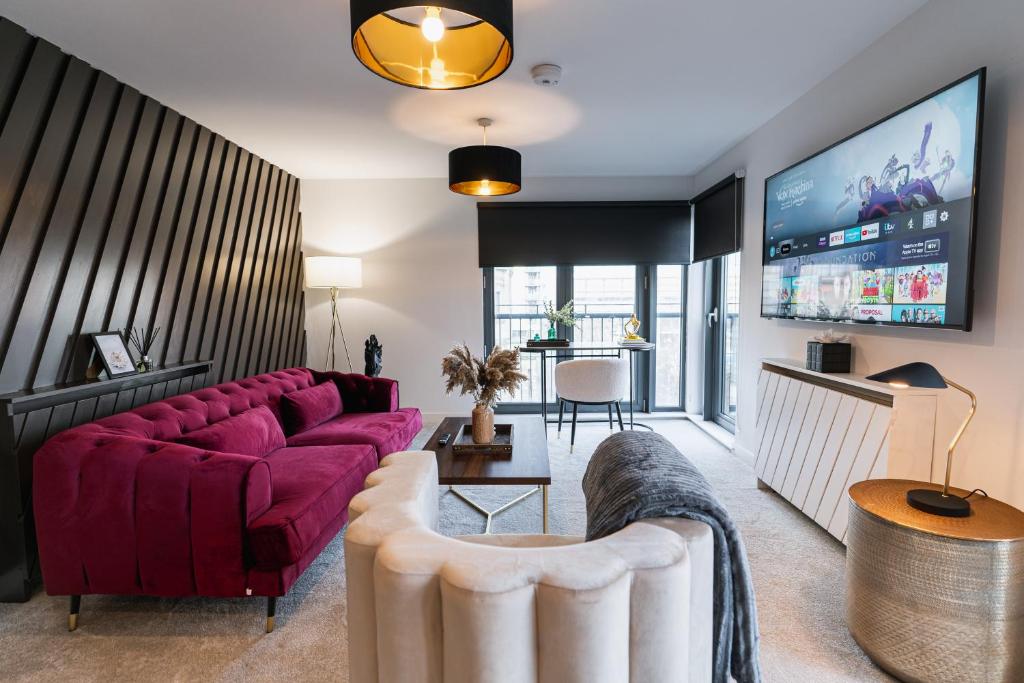 a living room with a purple couch and a tv at The Lusso Suite - 2BR - A 5* Escape Like No Other in Glasgow