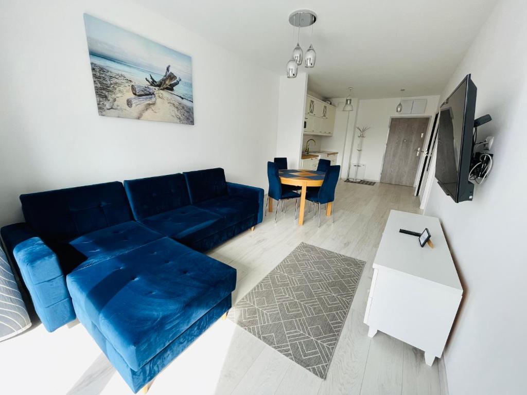 Televízia a/alebo spoločenská miestnosť v ubytovaní Promenada Gwiazd 14 by Baltic Home