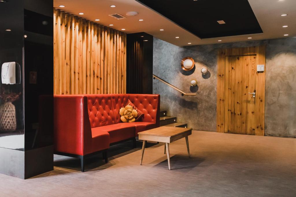 a red couch and a table in a room at H Boutique Peña Parda in La Herradura