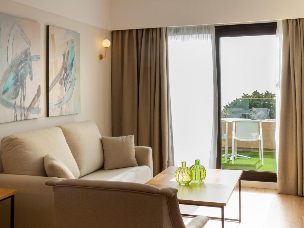 a living room with a couch and a table at Alexandre Grand Teguise Playa in Costa Teguise