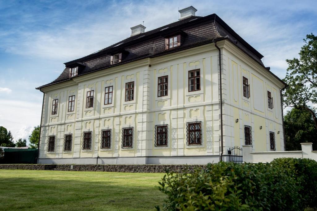 a large white building with a black roof at Chateau Diva in Turčianske Teplice