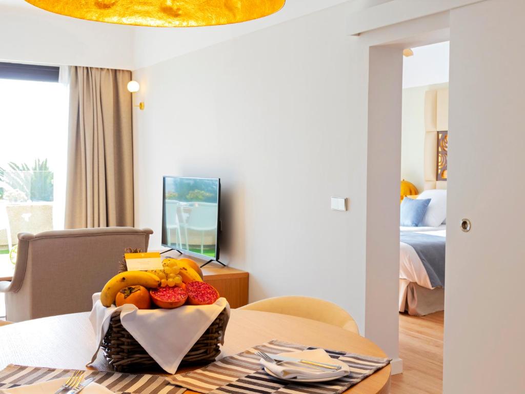 a table with a bowl of fruit on top of it at Alexandre Grand Teguise Playa in Costa Teguise