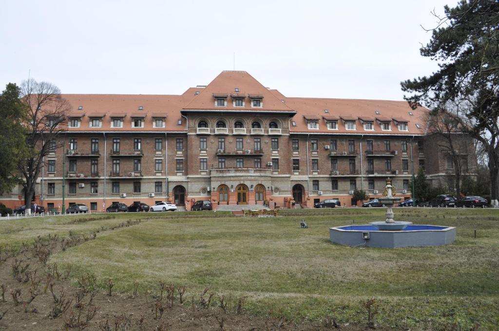 a large building with a fountain in front of it at Hotel Triumf in Bucharest