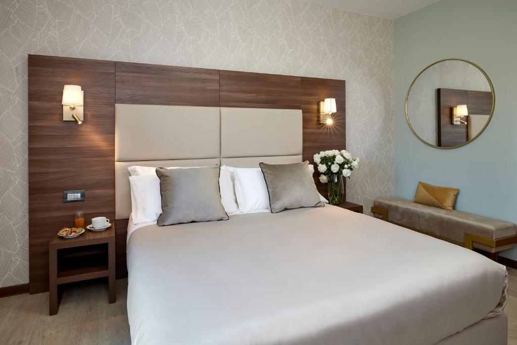 Postel nebo postele na pokoji v ubytování Hotel Spigamonti