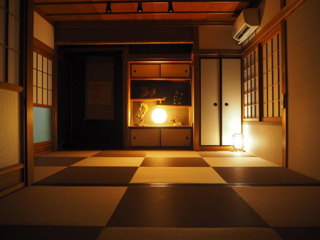a room with a checkered floor with a candle in it at Nara Park Blue Sky in Nara