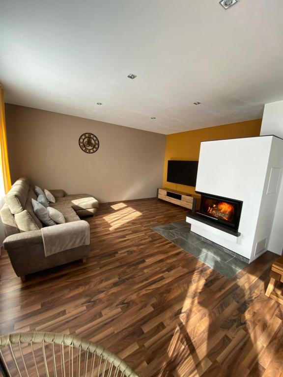 a living room with a couch and a fireplace at Ferienwohnung 2 Schweizer in Geisingen
