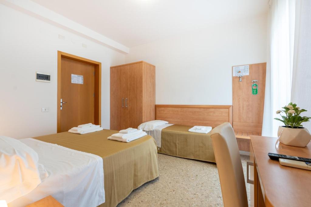 Postel nebo postele na pokoji v ubytování Hotel La Pineta