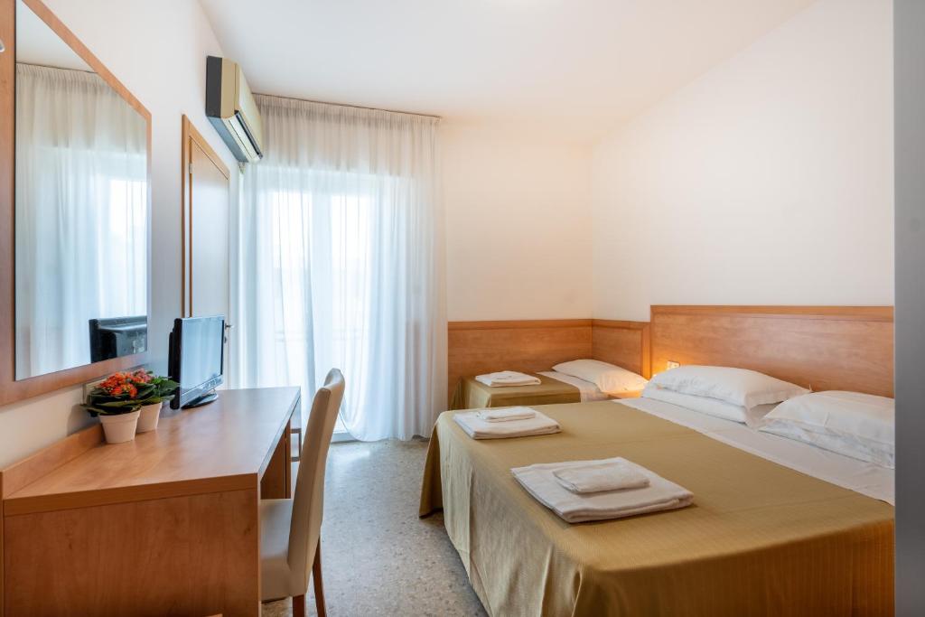 Postel nebo postele na pokoji v ubytování Hotel La Pineta