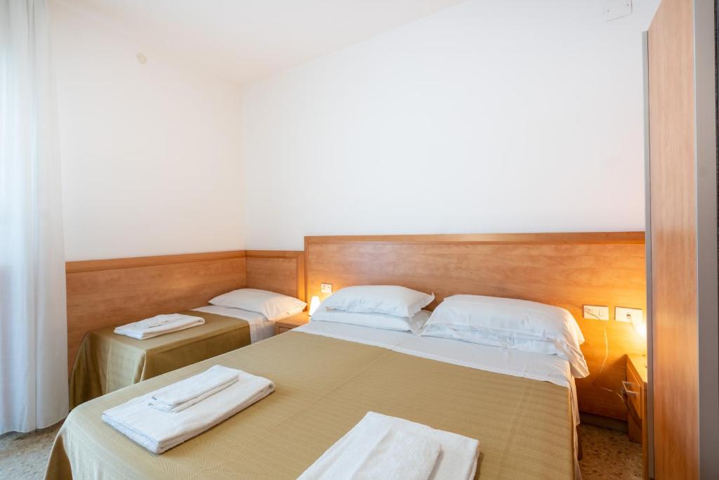 Postel nebo postele na pokoji v ubytování Hotel La Pineta