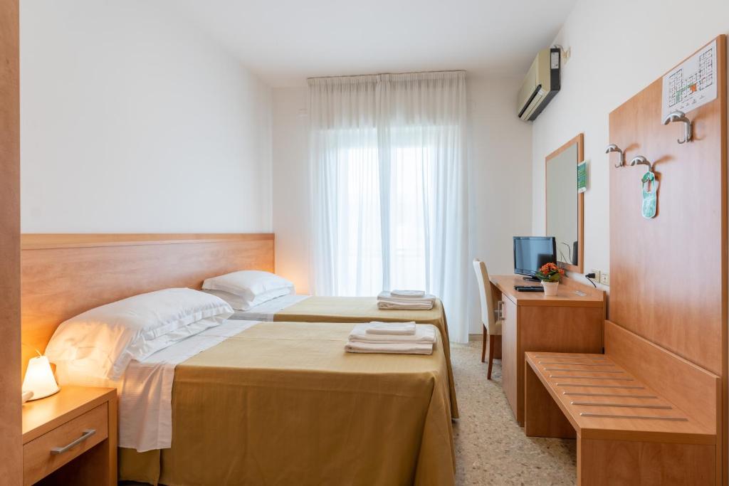 Postel nebo postele na pokoji v ubytování Hotel La Pineta
