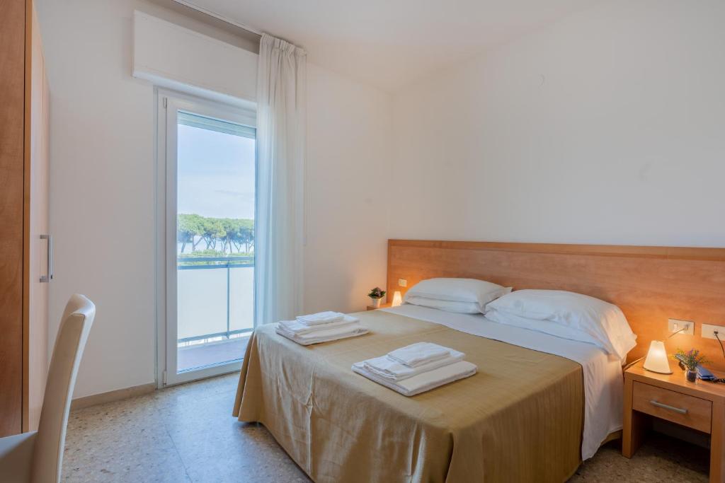 Postel nebo postele na pokoji v ubytování Hotel La Pineta