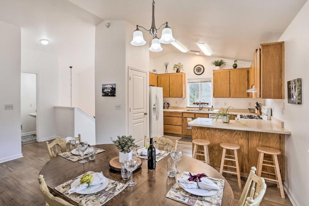 a kitchen and dining room with a table and chairs at Mount Shasta Escape with Balcony about Walk to Dtwn in Mount Shasta