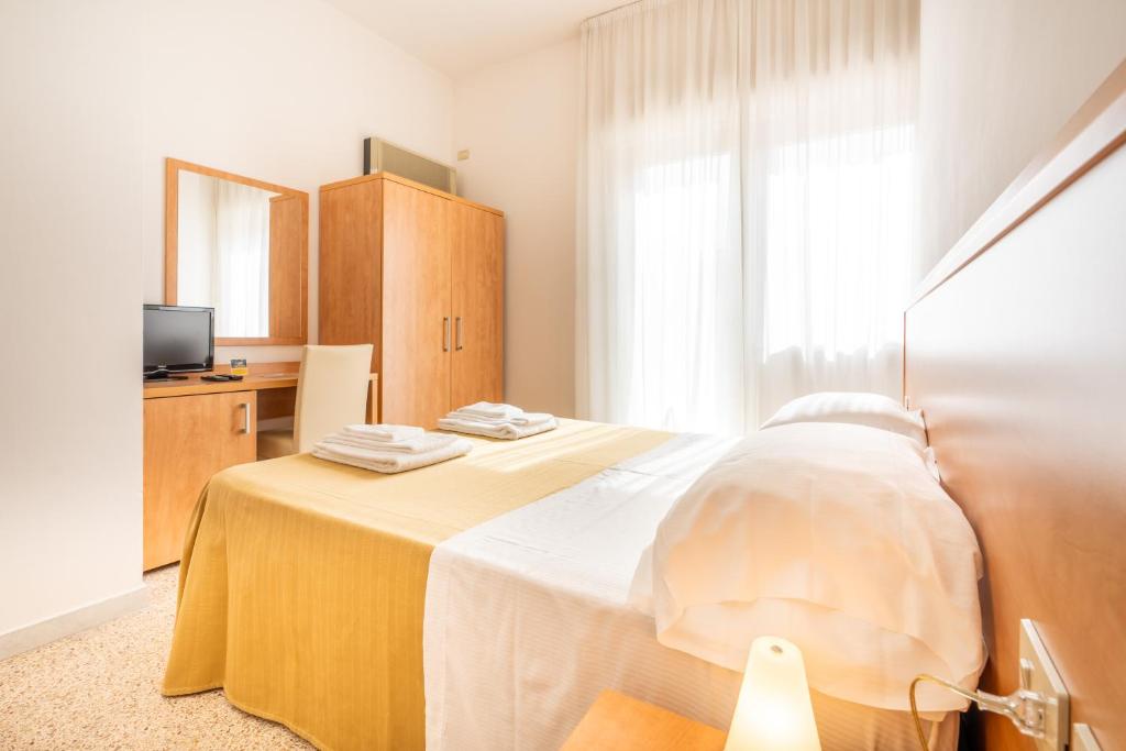 Postel nebo postele na pokoji v ubytování Hotel La Pineta