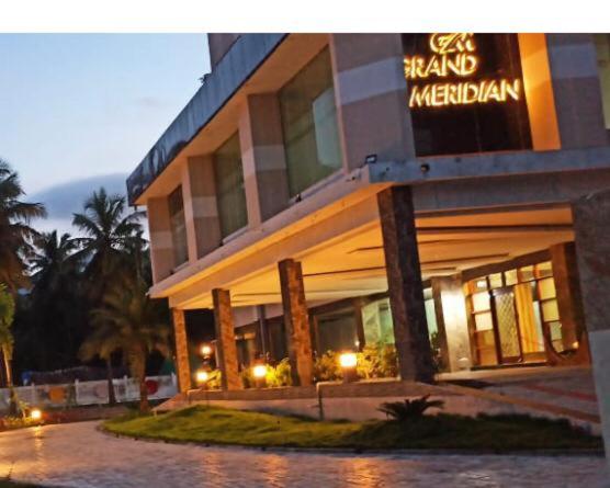 a hotel with a sign on the front of it at GRAND Meridian in Pyāpali