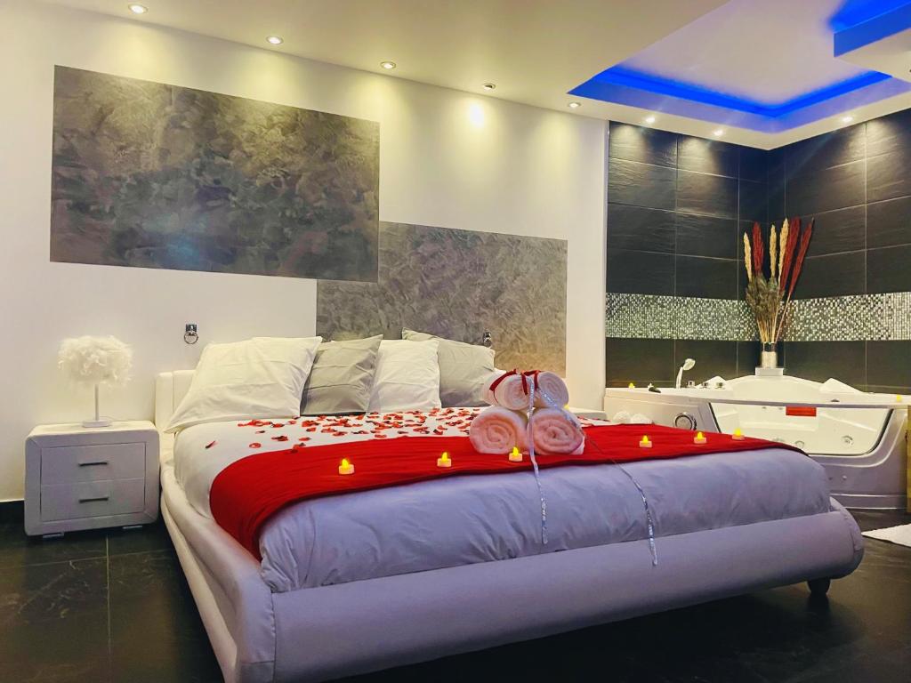 a bedroom with a large bed with a red blanket at La desiroom in Fréjus