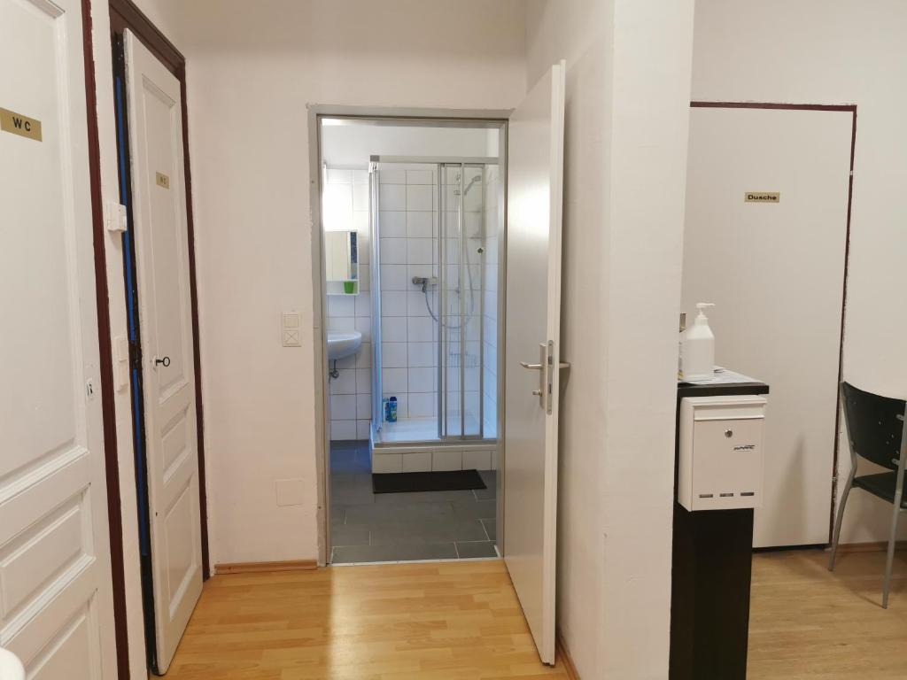 a bathroom with a walk in shower and a sink at 7brunnen Hostel Beds & Rooms in Vienna