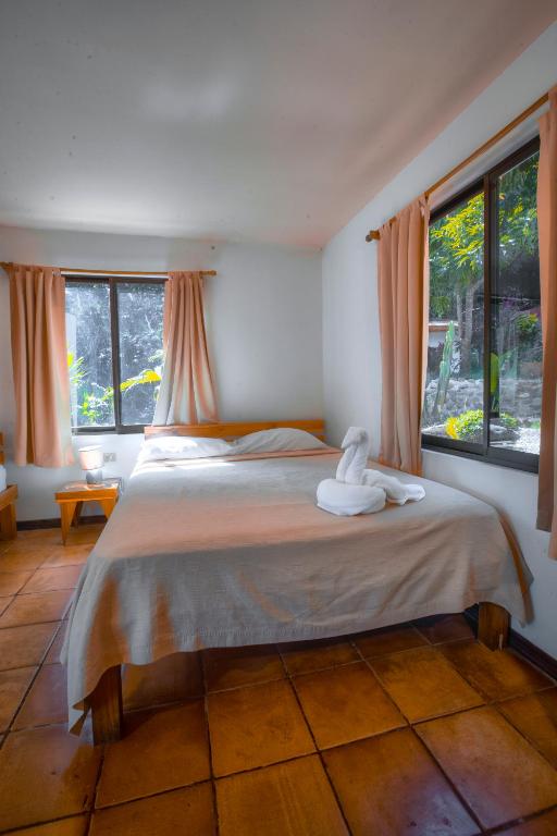Postel nebo postele na pokoji v ubytování Hotel El Jardin