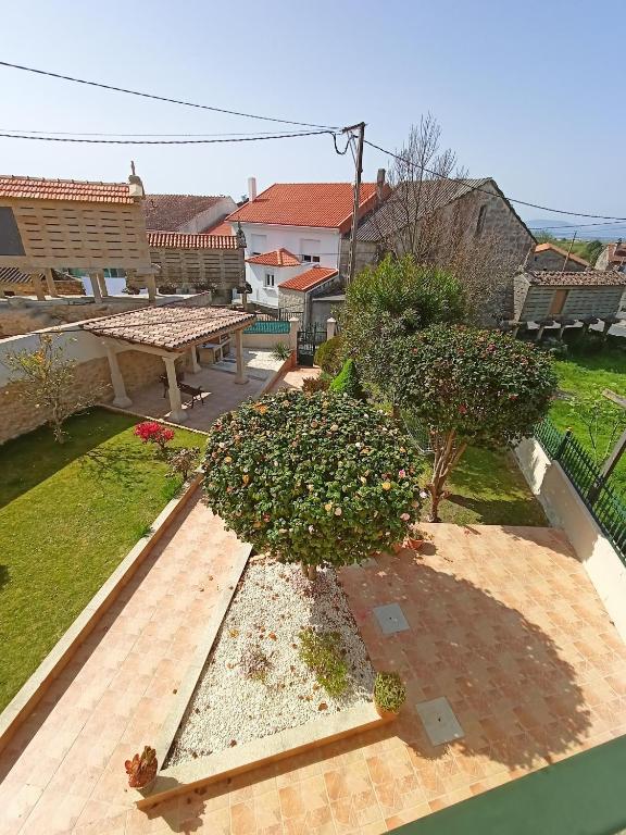 an aerial view of a garden with a bench and flowers at Casa López in San Mamede de Carnota