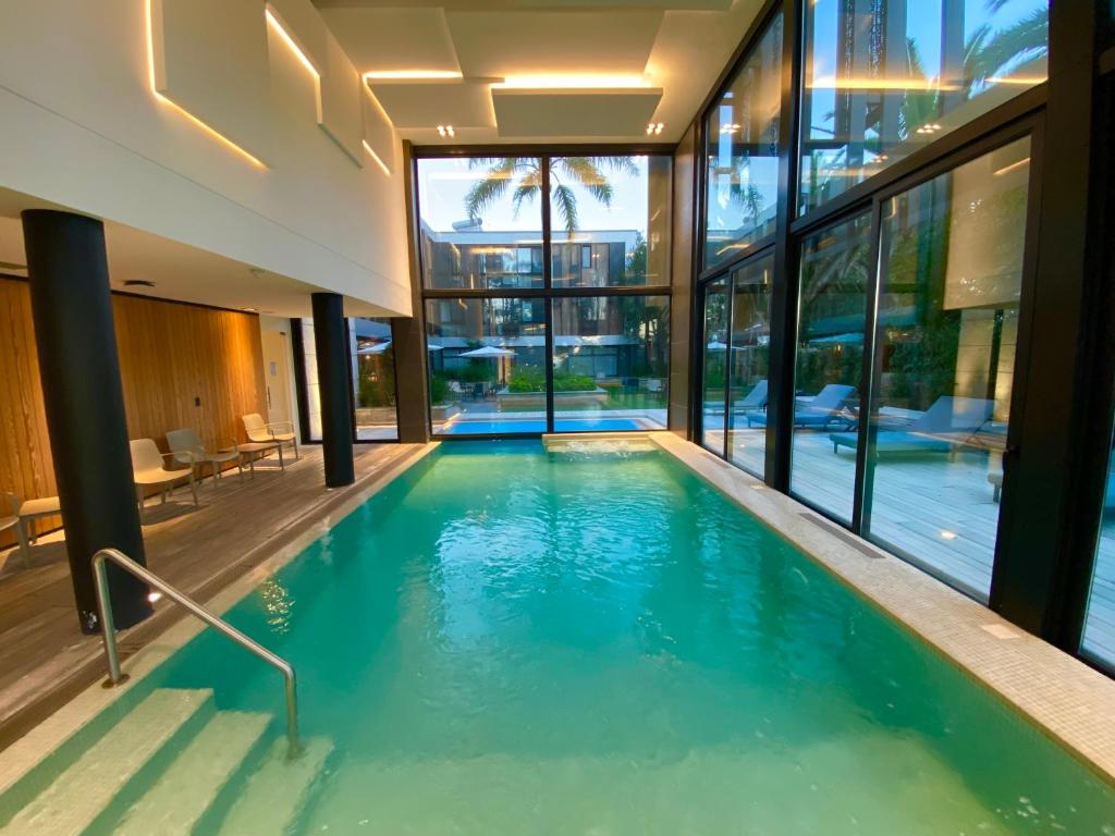 a swimming pool in the middle of a house at La Capilla - Punta del Este in Punta del Este