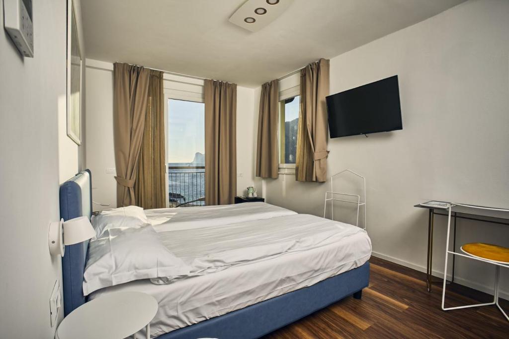 Postel nebo postele na pokoji v ubytování Hotel Paradiso Conca d'Oro