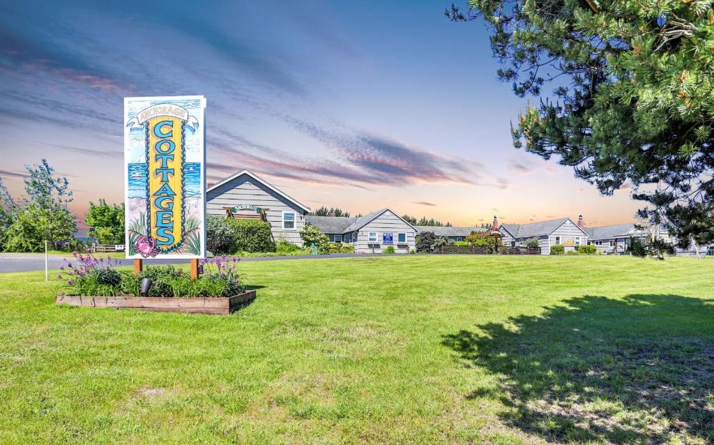 a sign in the middle of a yard with houses at Anchorage Cottages in Long Beach