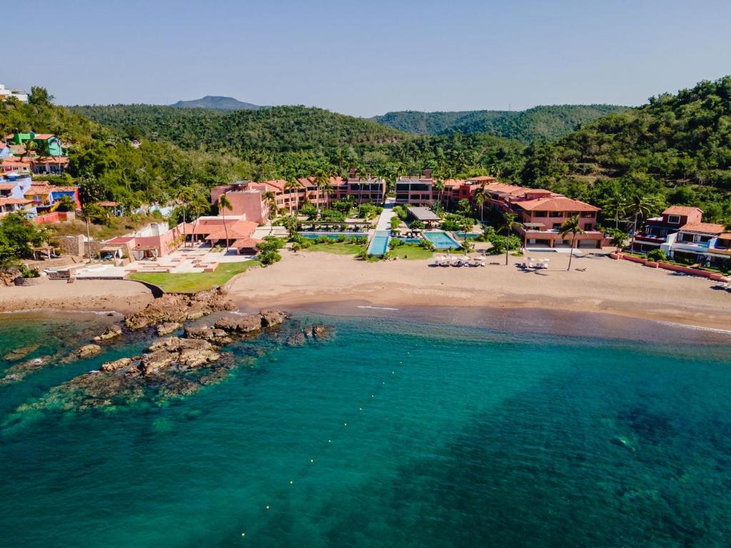 an aerial view of a beach with a resort at El Careyes Club & Residences in Careyes