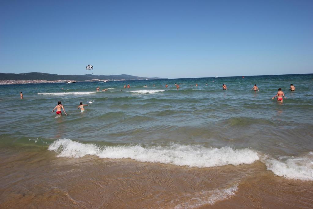 a group of people in the water at the beach at Menada Miramar Palace Apartments in Sunny Beach