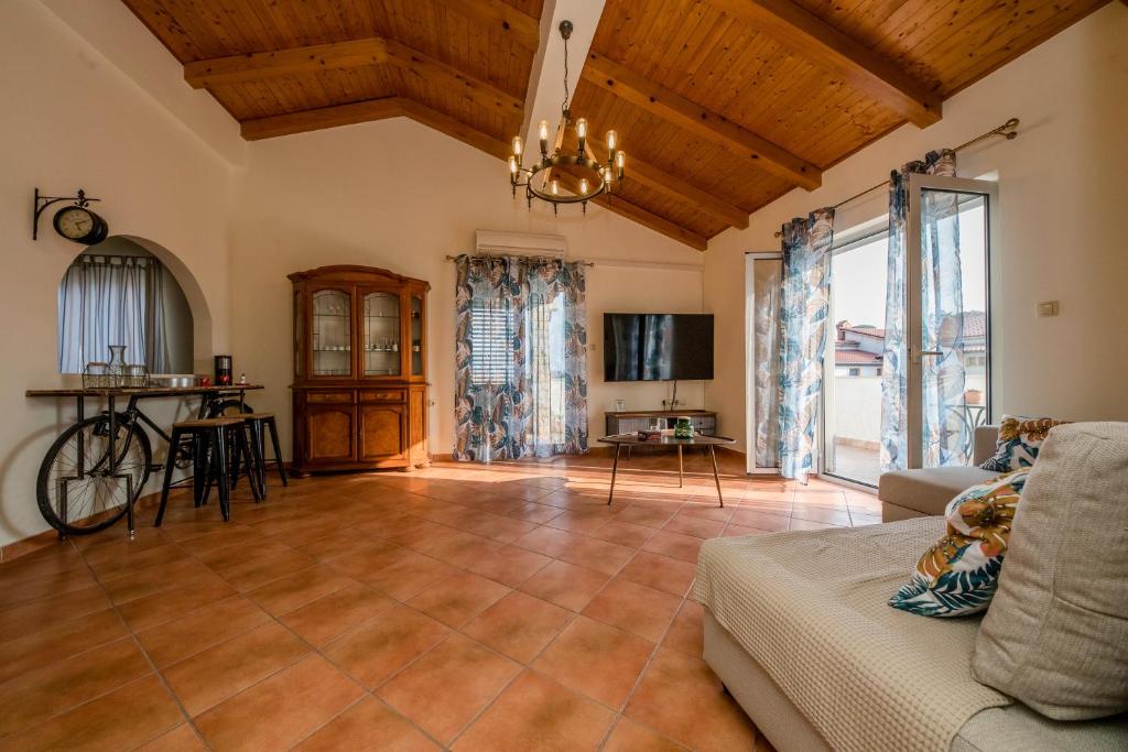 a living room with a couch and a table at Nikolina Rab Apartments in Rab