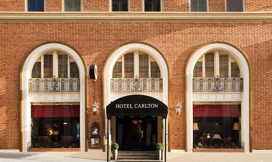 a brick building with two entrances to a hotel camera at FOUND Hotel Carlton, Nob Hill in San Francisco