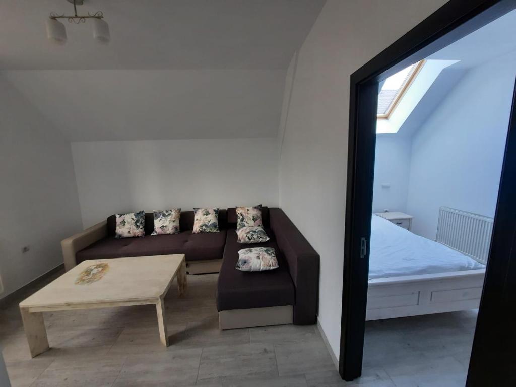 a living room with a couch and a table at Casa de oaspeti Maximilian in Codlea