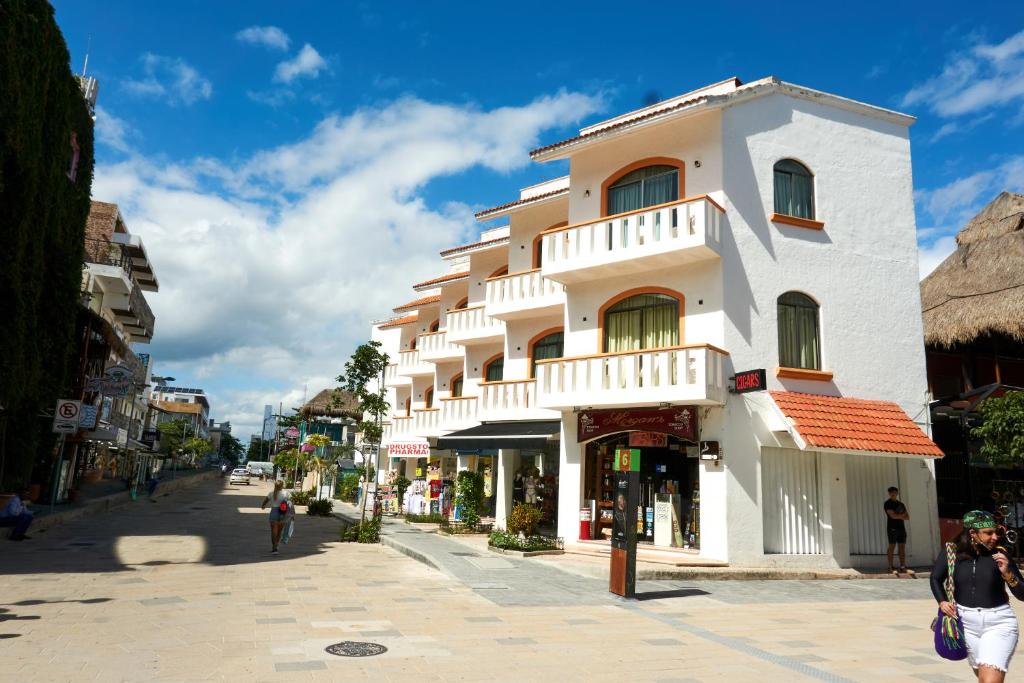 a large white building on a city street at Beach Balance in Playa del Carmen