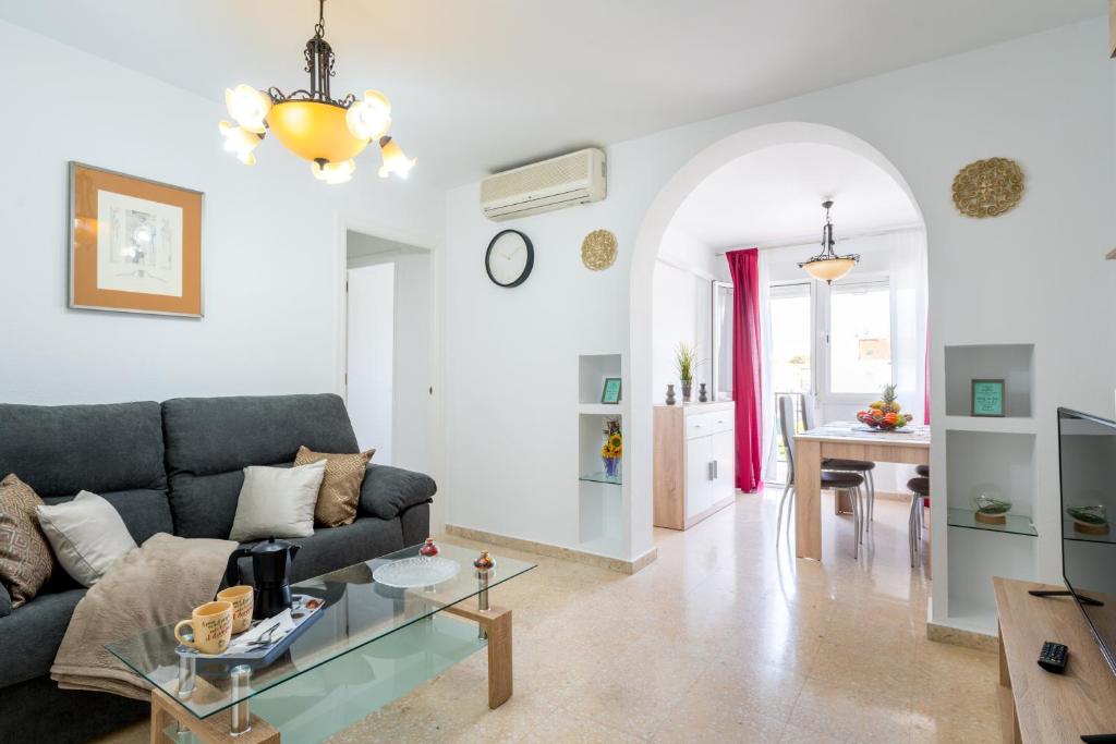 a living room with a couch and a table at Piso 3 dormitorios HL Gines a 10" de Sevilla, a 20" del Aeropuerto de Sevilla in Ginés