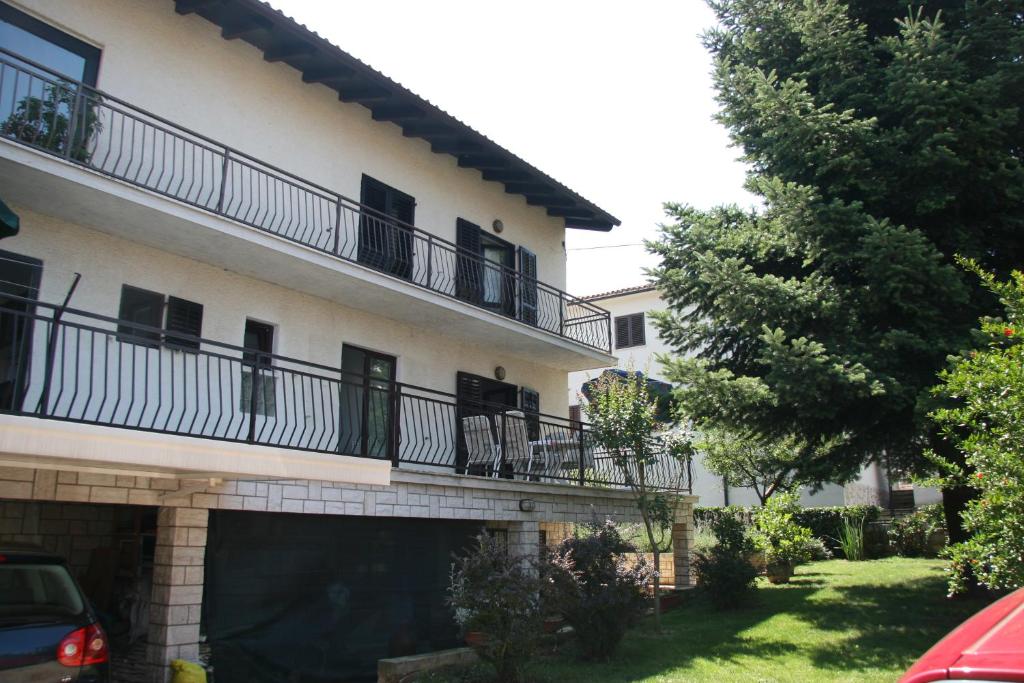 a building with balconies on the side of it at Pineta House Vidos in Poreč