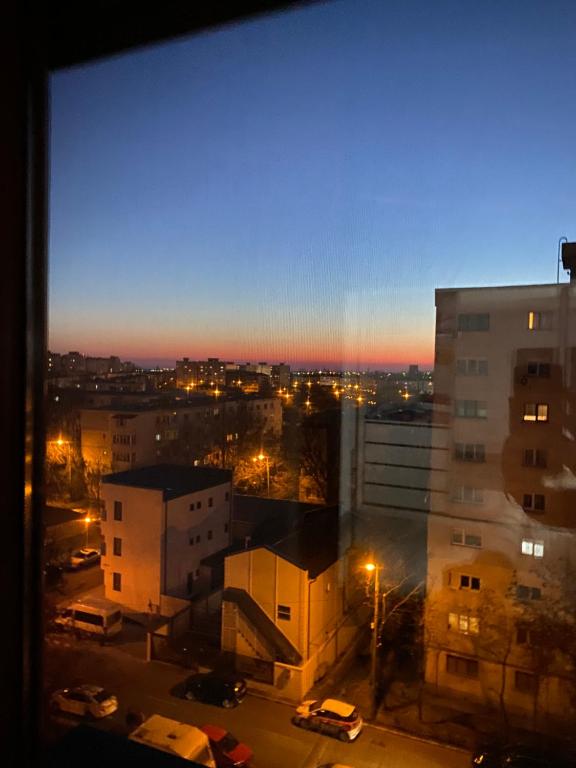 a view from a window of a city at night at Stephanie Apartment in Galaţi
