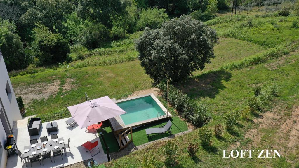 an aerial view of a house with a pool and umbrella at Corse et Zen LOFT ZEN 145m2 8à9 pers in Taglio-Isolaccio