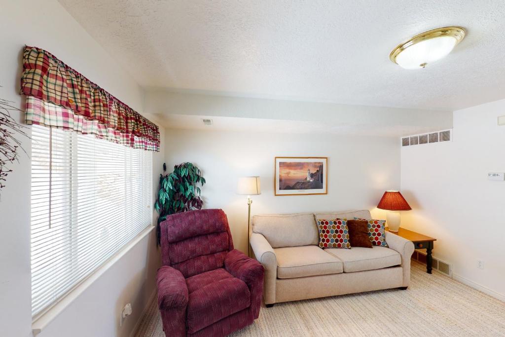 a living room with a couch and a chair at Marina Retreat in Garden City