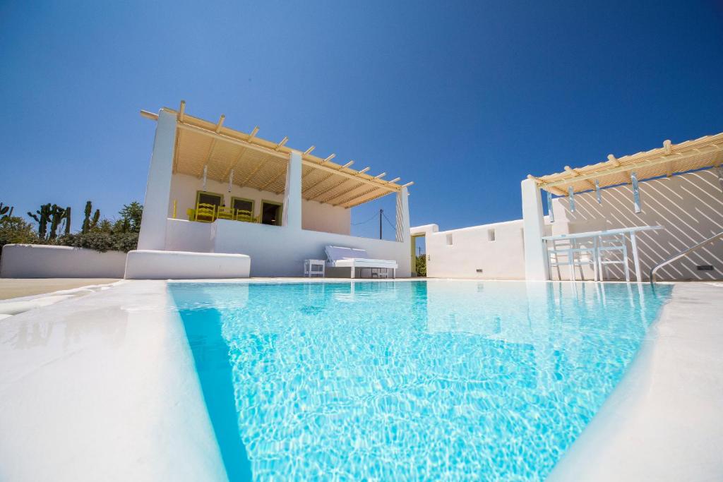 a swimming pool in front of a house at Villa Agrikoia in Oia