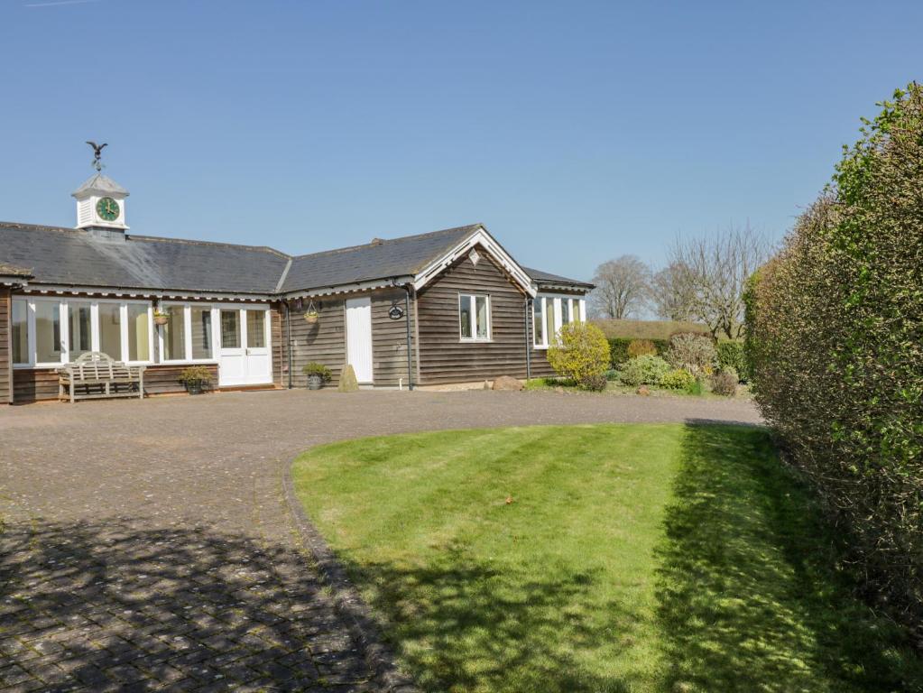 a house with a large yard in front of it at Clock Tower Cottage in Great Bedwyn