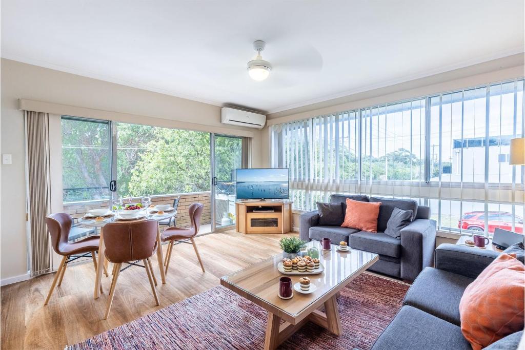 a living room with a couch and a table at 3 Fingal Court in Fingal Bay