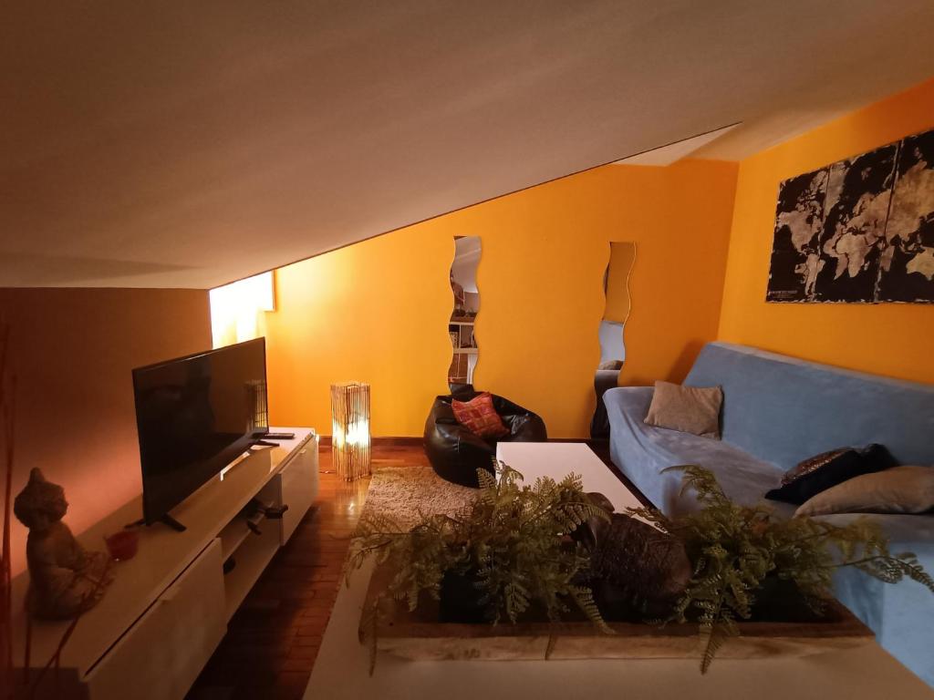 a living room with a blue couch and a television at NAMASTÉ Avenida Compostela 6, 4B sin ascensor in Palas de Rei