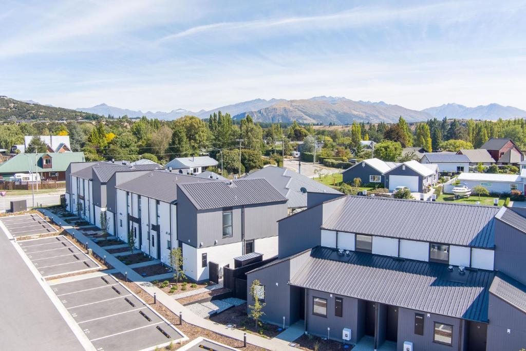 an aerial view of a town with buildings at Alpine Junction Townhouse Apartments, Lodge & Hotel in Wanaka