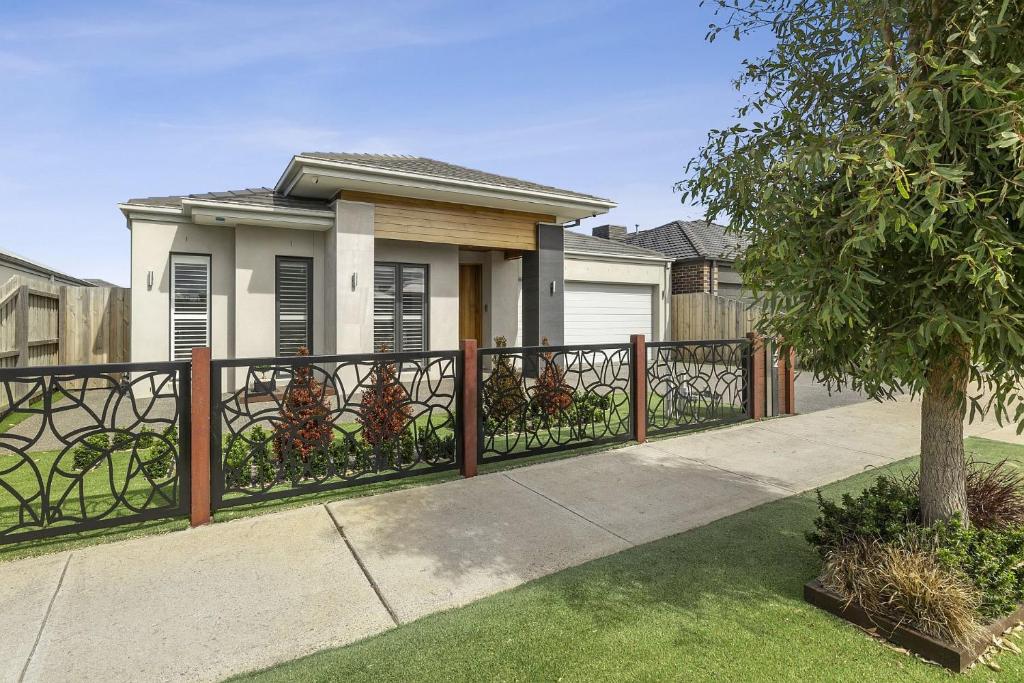 a fence in front of a house at Lowtide Five Bedroom 22 in Torquay