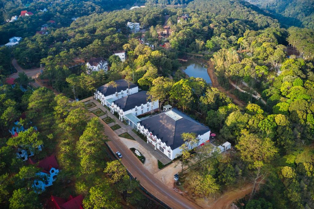 an aerial view of a building in the middle of a forest at Golden Boutique Hotel Mang Den in Kon Tum