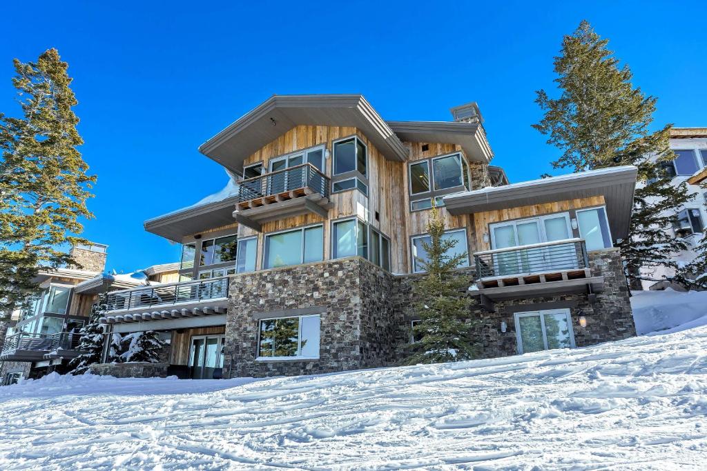 a house on top of a snow covered hill at Stunning 6-Bedroom Chalet in Heart of Park City home in Park City