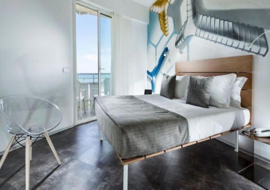 Postel nebo postele na pokoji v ubytování Hotel Rex - Fronte mare Riccione