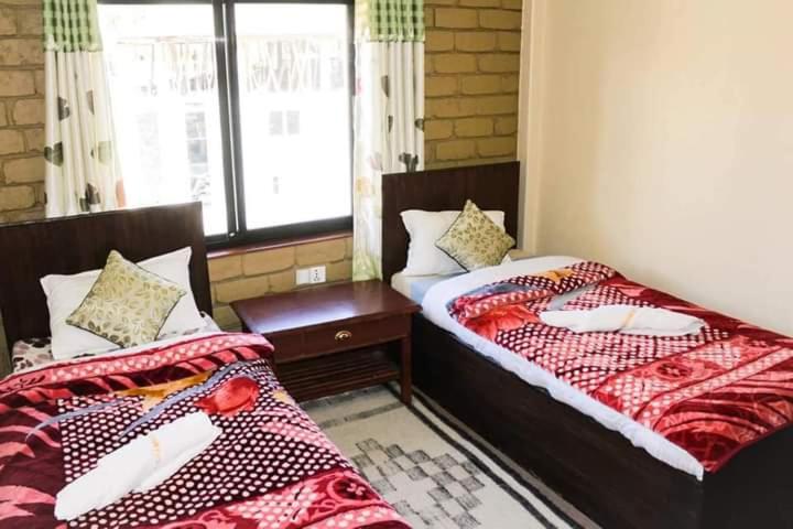 Postel nebo postele na pokoji v ubytování Hotel Grand Shambala