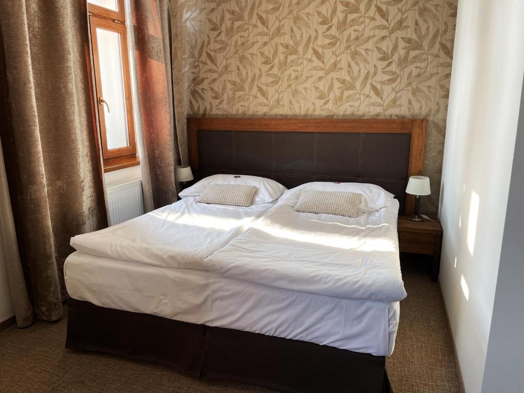 Postel nebo postele na pokoji v ubytování Hotel U Kvapilů