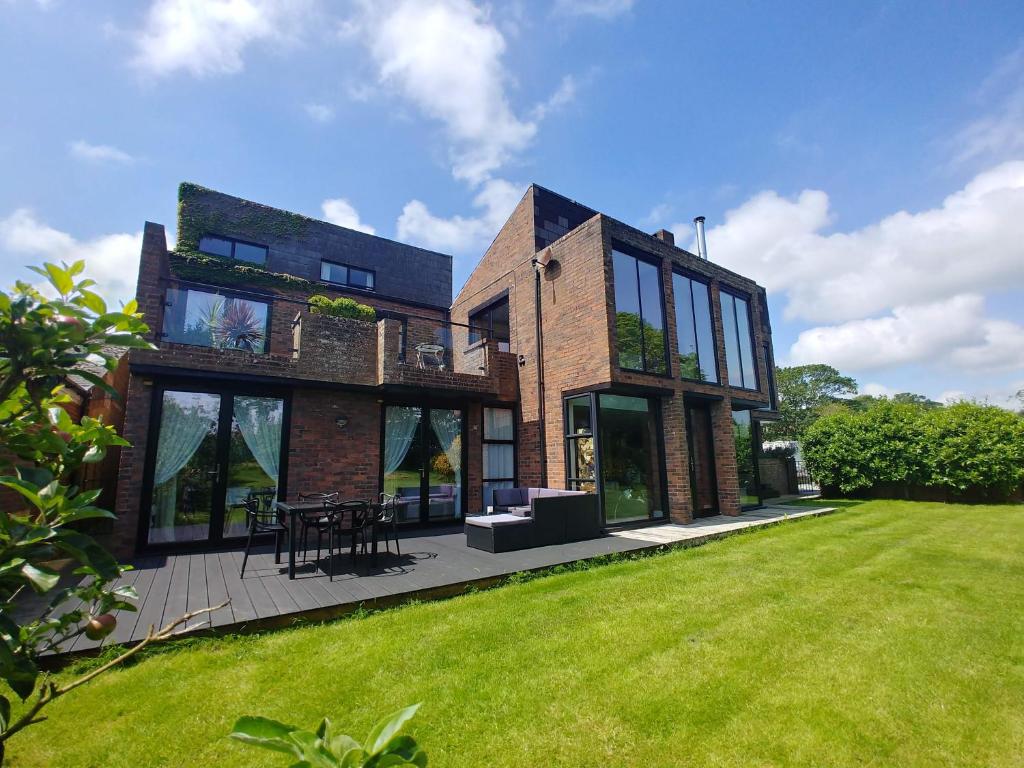 a large brick house with a lawn in front of it at Portreeves in Arundel